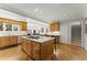 Spacious kitchen boasts an island cooktop, wooden cabinets, hardwood floors, and breakfast bar at 300 Morganshire Pl, Atlanta, GA 30350
