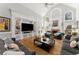 Spacious living room with hardwood floors, fireplace, built-in shelving, and high ceilings at 300 Morganshire Pl, Atlanta, GA 30350