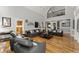 Bright living room with hardwood floors, high ceilings, a ceiling fan, and large windows at 300 Morganshire Pl, Atlanta, GA 30350
