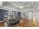 Main bedroom showcases a tray ceiling, recessed lighting, and hardwood flooring at 300 Morganshire Pl, Atlanta, GA 30350