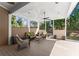 Outdoor patio with ample seating, ceiling fan, and views of landscaped yard at 300 Morganshire Pl, Atlanta, GA 30350