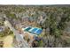 Aerial view of community tennis courts with green and blue surfaces, surrounded by mature trees and a nearby street at 300 Morganshire Pl, Atlanta, GA 30350