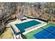 Aerial view of community pool and tennis courts surrounded by trees and fencing for recreational opportunities at 300 Morganshire Pl, Atlanta, GA 30350
