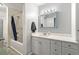 Bathroom features a shower-tub combo, vanity and decorative mirror at 4131 N Gloucester Pl, Atlanta, GA 30341