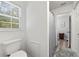 Toilet in bathroom with shower/tub, and window at 4131 N Gloucester Pl, Atlanta, GA 30341