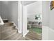 Inviting entryway with a carpeted staircase and view into the living room with a comfortable gray sofa at 4131 N Gloucester Pl, Atlanta, GA 30341