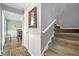 Bright entryway with carpeted stairs, a view to the dining room, and decorative wall accents at 4131 N Gloucester Pl, Atlanta, GA 30341