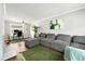 Spacious living room featuring a gray sectional sofa, a working desk and a modern ceiling fan at 4131 N Gloucester Pl, Atlanta, GA 30341