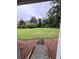 View of the spacious backyard, complete with a patch of gravel leading to the grassy area at 4925 Happy Hollow Rd, Dunwoody, GA 30360