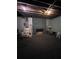 Unfinished basement featuring a stone fireplace, exposed ceiling, and ample space for renovation at 4925 Happy Hollow Rd, Dunwoody, GA 30360