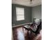 Unique bedroom with hardwood floors, a gaming setup, and a picture window providing ample sunlight at 4925 Happy Hollow Rd, Dunwoody, GA 30360