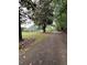 Long driveway leading to house surrounded by mature trees and lush lawn at 4925 Happy Hollow Rd, Dunwoody, GA 30360