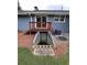 The home has a deck, brick basement door, and is surrounded by pine straw at 4925 Happy Hollow Rd, Dunwoody, GA 30360