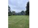 Classic ranch home featuring a lush lawn, mature trees, and a well-maintained exterior at 4925 Happy Hollow Rd, Dunwoody, GA 30360