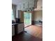 Cozy kitchen featuring white cabinetry, black countertops, and sliding glass doors leading to the backyard deck at 4925 Happy Hollow Rd, Dunwoody, GA 30360