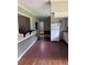 Kitchen featuring white appliances and cabinets with breakfast bar to other living area at 4925 Happy Hollow Rd, Dunwoody, GA 30360
