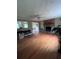 Hardwood living room featuring brick fireplace, plenty of natural light and opens to kitchen at 4925 Happy Hollow Rd, Dunwoody, GA 30360