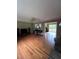 Spacious living room with hardwood floors, ceiling fan and access to the back patio at 4925 Happy Hollow Rd, Dunwoody, GA 30360