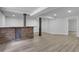 Finished basement area with a brick bar, neutral paint, recessed lighting, and light wood flooring at 644 Church Nw St, Atlanta, GA 30318