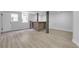 Finished basement featuring light wood flooring, neutral paint, and a stylish brick bar under natural light at 644 Church Nw St, Atlanta, GA 30318