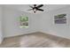 Serene bedroom with ample natural light, neutral walls, ceiling fan, and light wood-look flooring at 644 Church Nw St, Atlanta, GA 30318