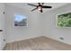 Inviting bedroom with natural light, neutral walls, ceiling fan, and beautiful light wood-look flooring at 644 Church Nw St, Atlanta, GA 30318
