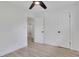 Bright bedroom with a ceiling fan, light wood floors, and access to other rooms via doorways at 644 Church Nw St, Atlanta, GA 30318