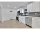 Modern kitchen with white cabinets, stainless steel appliances, and stylish backsplash at 644 Church Nw St, Atlanta, GA 30318