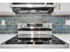Stainless steel range, hood and backsplash against the quartz countertop of the kitchen at 644 Church Nw St, Atlanta, GA 30318
