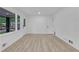 Bright living room with light wood floors, a large window, and a door leading to the backyard at 644 Church Nw St, Atlanta, GA 30318