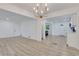 Bright and airy open-concept living room with a modern chandelier and beautiful light wood flooring at 644 Church Nw St, Atlanta, GA 30318