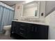 Bathroom featuring modern vanity with dual sinks and a tiled shower at 126 Brittany Dr, Canton, GA 30115