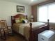 Comfortable bedroom featuring a rocking chair, bedside lamps, and a chest at 126 Brittany Dr, Canton, GA 30115