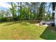 Spacious backyard with lush lawn, mature trees, and a patio area for outdoor enjoyment at 1934 Glen Echo Dr, Decatur, GA 30032