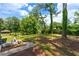 Large backyard with mature trees, green lawn, and patio area for outdoor entertaining at 1934 Glen Echo Dr, Decatur, GA 30032