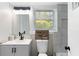 Bathroom with a modern vanity, decorative accessories, and a tiled shower area at 1934 Glen Echo Dr, Decatur, GA 30032