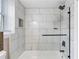 The bathroom features a tiled tub, modern fixtures, and a glass shower door at 1934 Glen Echo Dr, Decatur, GA 30032