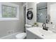This bathroom has a modern vanity, toilet, and a window for natural light at 1934 Glen Echo Dr, Decatur, GA 30032