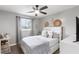 Bedroom with a white headboard, ceiling fan, and neutral-colored decor at 1934 Glen Echo Dr, Decatur, GA 30032