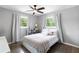 This bedroom has hardwood floors, a ceiling fan, and bright, sunlit windows at 1934 Glen Echo Dr, Decatur, GA 30032