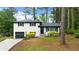 Charming white brick home with a well-manicured lawn and an attached garage at 1934 Glen Echo Dr, Decatur, GA 30032