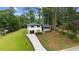 Aerial view of charming two-story home with mature trees and a long driveway at 1934 Glen Echo Dr, Decatur, GA 30032