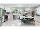 Stylish kitchen with stainless steel appliances, white cabinets, and adjoining dining area with modern table at 1934 Glen Echo Dr, Decatur, GA 30032