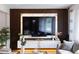 Stylish living room with a large TV mounted above a white cabinet with mood lighting at 1934 Glen Echo Dr, Decatur, GA 30032
