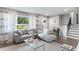 Bright living room features stylish gray couch, decorative rug, and natural light through large window at 1934 Glen Echo Dr, Decatur, GA 30032