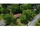 An aerial perspective of a cozy home shaded by lush trees in a residential neighborhood at 2368 Ellis Court, Snellville, GA 30078