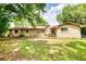 Spacious backyard featuring mature trees and a brick house with a deck and lots of green space at 2368 Ellis Court, Snellville, GA 30078