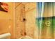 The bathroom features stone shower/tub combination and tan-tiled shower walls at 2368 Ellis Court, Snellville, GA 30078
