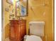 The bathroom features a vanity, a standard toilet, decorated with vintage decor, and yellow walls at 2368 Ellis Court, Snellville, GA 30078