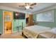 Bedroom features a doorway to bathroom, closet and a television mounted on the wall at 2368 Ellis Court, Snellville, GA 30078